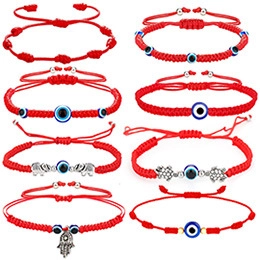 Set of red woven evil eye bracelets with silver elephant and hamsa hand charms