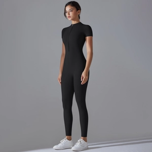 Side view of black one-piece yoga suit with front zipper and slim fit athletic silhouette