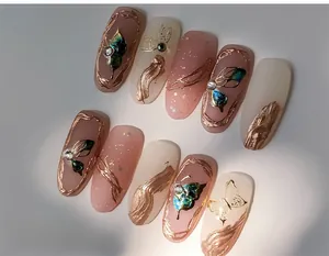 Detail of 5D embossed nail stickers featuring pink butterfly and metallic 3D relief art