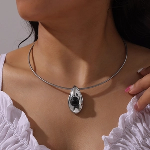 Minimalist titanium steel necklace with black agate teardrop pendant on leather cord