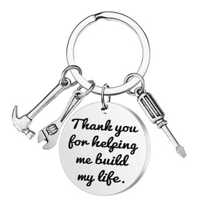 Detail of stainless steel keychain with tools and 'Thank you for helping me build my life' text