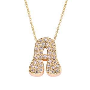 Detailed view of golden cursive letter A pendant necklace with micro zircon stones
