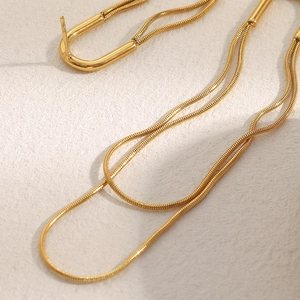 Close-up of elegant 18K gold plated stainless steel long snake chain drop earrings