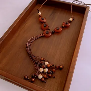Vintage ethnic wooden bead necklace with fringe tassel and agate stone details