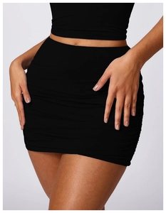 Detail view of the gathered ruched texture and slim side drawstring on a black mini skirt