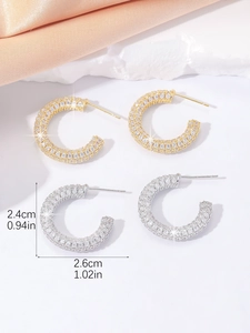 Detailed view of C-shaped hoop earrings in gold and silver with zircon insets, 2.6cm size