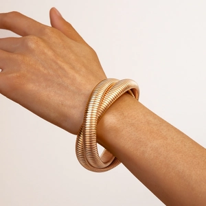 Elegant rose gold multi-coil wrap bracelet with textured metal finish on woman's wrist