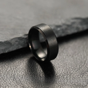 8mm matte black stainless steel men's ring with brushed finish on dark rocky background