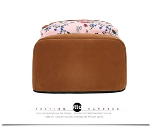 Detail view of the floral backpack bottom featuring durable brown faux suede material