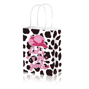 Detail of disco cowgirl party gift bag with cow print and Let's go girls text