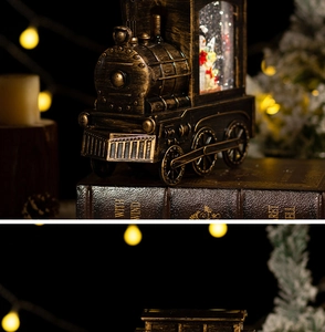 Detailed view of bronze Christmas train snow globe featuring warm glowing lights