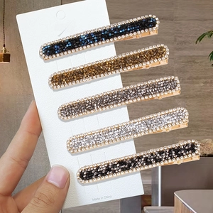 Five-piece set of minimalist metal hairpins with colorful rhinestones on a card