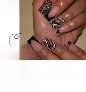 Short square press-on nails with pink base, black French tips and heart rhinestone details