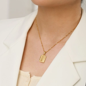 Macro view of 18K gold plated stainless steel square angel pendant with micro diamonds