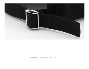 Detail of adjustable silver metal buckle and neat stitching on black canvas baseball cap