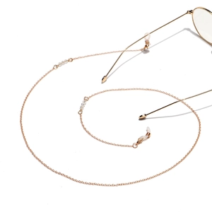 Detail of gold eyewear chain with transparent beads and non-slip rubber loop connectors