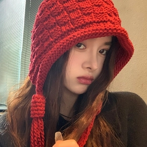 Fashionable red knit earflap hat with checkered pattern and long tassels for winter