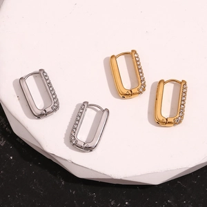 Detailed view of gold and silver U-shaped earrings with micro-pave cubic zirconia accents