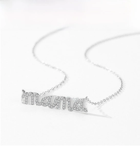 Macro detail of silver S925 necklace featuring a pavé diamond MAMA letter pendant