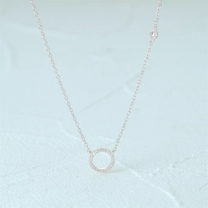 Macro detail of S925 sterling silver geometric circle pendant with sparkling diamonds