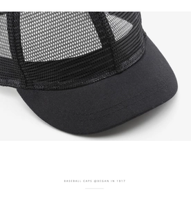 Detail of black baseball cap showing mesh back and cotton brim stitching