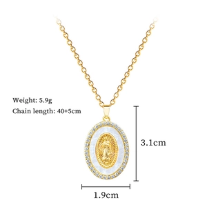 Detailed view of oval gold portrait pendant with shell inlay and crystal border