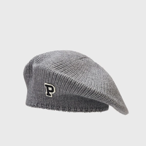 Close-up of gray knitted beret showing thick wool texture and black and white P-patch detail