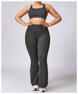 Close-up of high-waisted flared yoga pants and racerback sports bra in charcoal grey