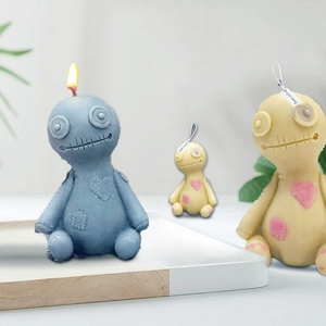 Macro detail of Voodoo doll candles with stitch textures and heart patch accents