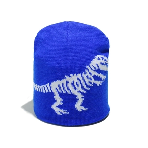 Detail of royal blue knitted beanie featuring white dinosaur skeleton jacquard pattern