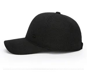 Side view of black men's winter baseball cap with ear flaps and textured tweed fabric