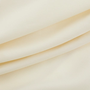Macro shot of off-white refined fabric texture with elegant wavy folds for mini dress