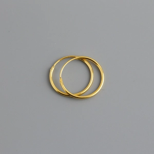 Detailed view of simple golden S925 sterling silver hoop earrings with a polished finish