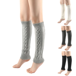 Detail of cable knit leg warmers showing gray, beige and black textured knit fabrics