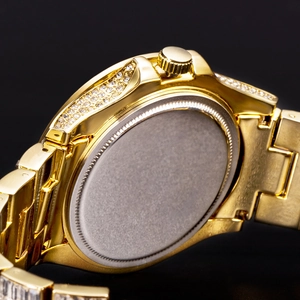 Macro view of gold metal watch band with luxury diamond setting and polished case back