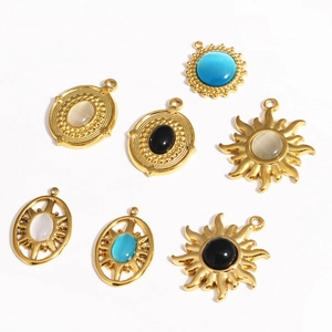 Detail of vintage gold steel pendants with cat eye stones in blue white and black