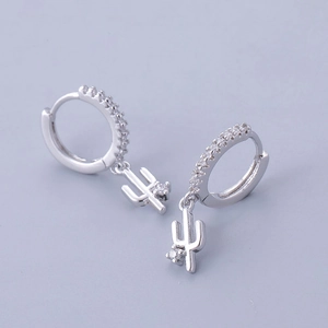 Detailed macro view of silver cactus earrings with shimmering pavé zircon stones