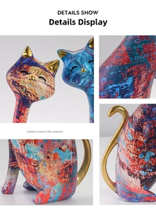 Close-up of abstract cat figurines with colorful graffiti art and elegant gold accents