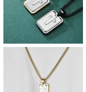 Macro detail of men's layered cross pendant necklace with silver and gold accents
