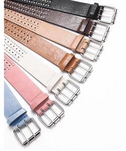 Close-up of colorful faux leather belts featuring star rivets and dual-pin metal buckles