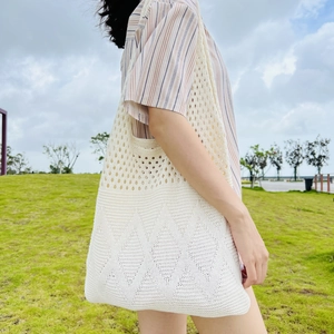Minimalist beige crochet knit tote bag with diamond cutout pattern for women outdoors