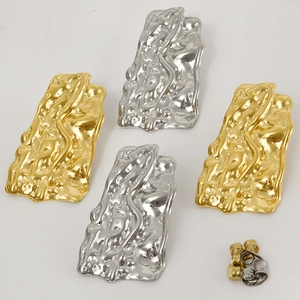 Detail of 304 stainless steel earrings with gold and silver irregular hammered textures