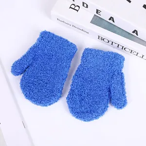 Detailed close-up of warm blue coral fleece mittens showing soft textured plush material