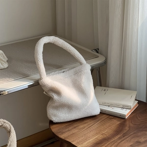 White fluffy lamb wool handbag for winter with soft plush texture and minimalist design