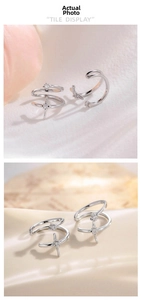 Detail showing a silver double-layered ear bone clip with a sparkling star starburst charm