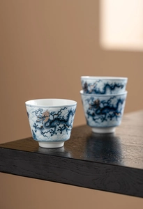 Detailed macro view of ceramic teacup with exquisite blue and gold dragon motifs