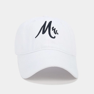 Detailed view of white cotton twill baseball cap with black embroidered Mr script text