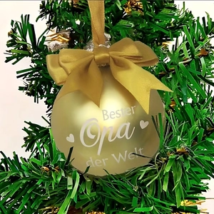 Matte gold Christmas ball with bow on tree featuring Bester Opa der Welt text