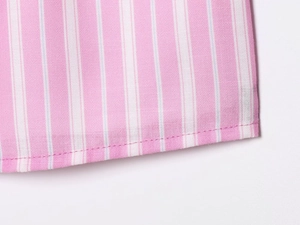 Close-up of pink and white vertical striped fabric showing detailed stitching and texture