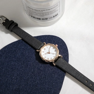 Vintage women's watch with rose gold case, Roman numerals and black leather strap